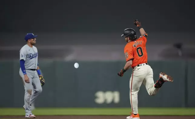 San Francisco Giants' Brett Wisely, right, celebrates after hitting a game-winning, two-run home run against the Los Angeles Dodgers during the ninth inning of a baseball game Friday, June 28, 2024, in San Francisco. (AP Photo/Godofredo A. Vásquez)
