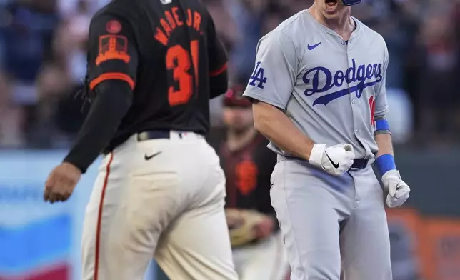 Los Angeles Dodgers' Will Smith, right, reacts after hitting a two-run double against the San Francisco Giants during the 11th inning of a baseball game Saturday, June 29, 2024, in San Francisco. (AP Photo/Godofredo A. Vásquez)