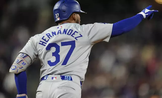 Los Angeles Dodgers' Teoscar Hernández gestures after hitting a three-run home run off Colorado Rockies relief pitcher Victor Vodnik during the ninth nning of a baseball game Tuesday, June 18, 2024, in Denver. (AP Photo/David Zalubowski)