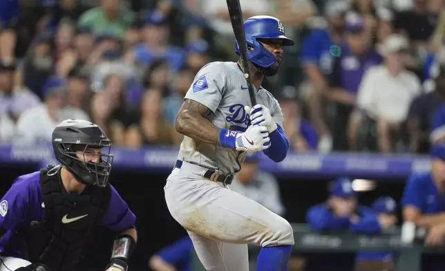 Los Angeles Dodgers' Jason Heyward follows the flight of his single to drive in two runs off Colorado Rockies relief pitcher Geoff Hartlieb in the eighth inning of a baseball game Monday, June 17, 2024, in Denver. (AP Photo/David Zalubowski)