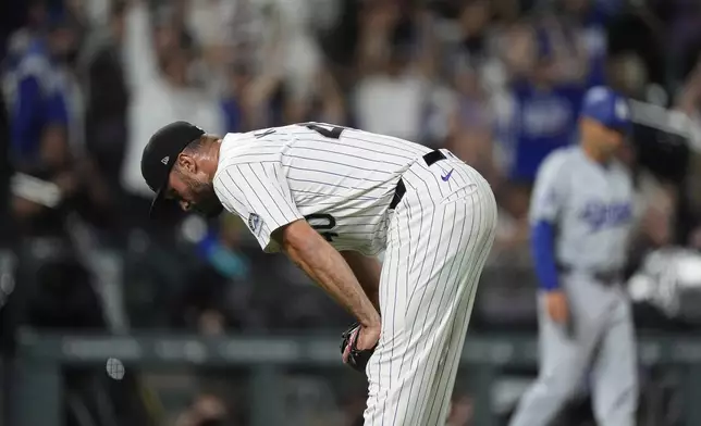 Colorado Rockies relief pitcher Tyler Kinley reacts after giving up a grand slam to Los Angeles Dodgers pinch-hitter Jason Heyward during the ninth inning of a baseball game Tuesday, June 18, 2024, in Denver. (AP Photo/David Zalubowski)