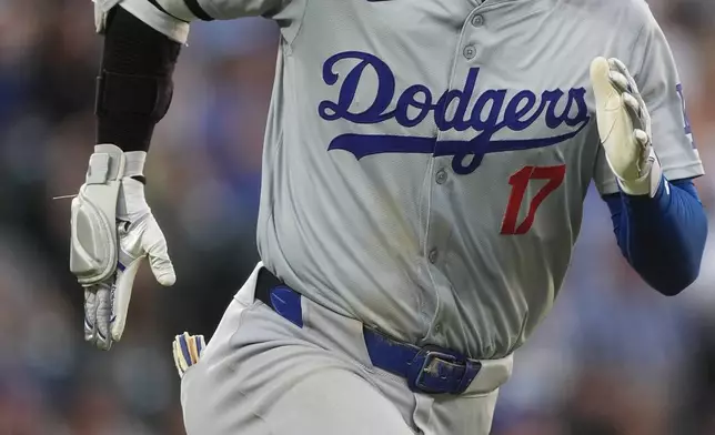 Los Angeles Dodgers' Shohei Ohtani heads up the first base line after connecting for a double off Colorado Rockies relief pitcher Jake Bird in the sixth inning of a baseball game Monday, June 17, 2024, in Denver. (AP Photo/David Zalubowski)