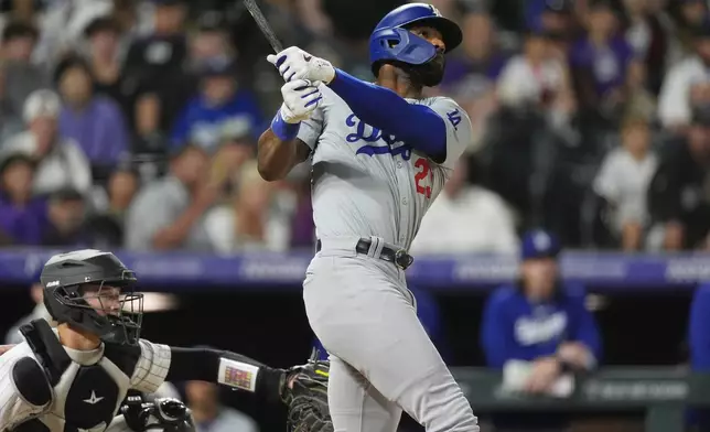 Los Angeles Dodgers pinch-hitter Jason Heyward watches his grand slam off Colorado Rockies relief pitcher Tyler Kinley during the ninth inning of a baseball game Tuesday, June 18, 2024, in Denver. (AP Photo/David Zalubowski)