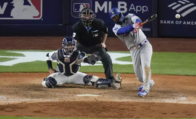 Los Angeles Dodgers' Teoscar Hernández (37) hits a two-run double during the eleventh inning of a baseball game against the New York Yankees, Friday, June 7, 2024, in New York. (AP Photo/Frank Franklin II)