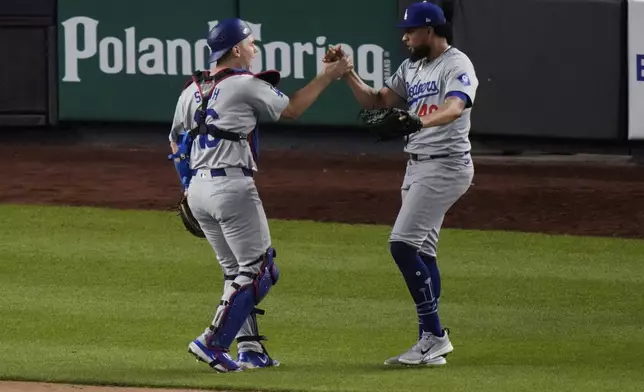 Los Angeles Dodgers pitcher Blake Treinen, right, celebrates with catcher Will Smith after the team's 2-1 win in 11 innings in a baseball game against the New York Yankees, Friday, June 7, 2024, in New York. (AP Photo/Frank Franklin II)