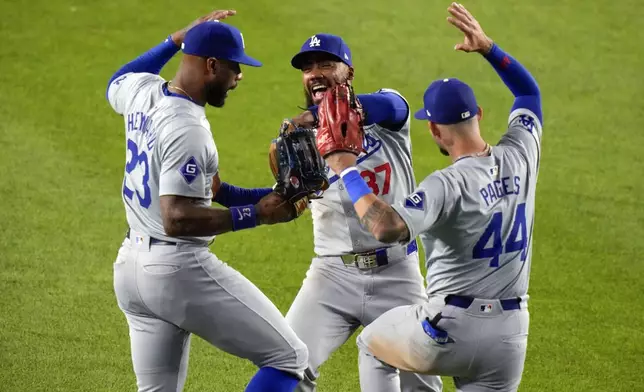 Los Angeles Dodgers' Teoscar Hernández (37) celebrates with teammates Jason Heyward (23) and Andy Pages (44) after a baseball gamea gainst the New York Yankees, Friday, June 7, 2024, in New York. The Dodgers won 2-1. (AP Photo/Frank Franklin II)
