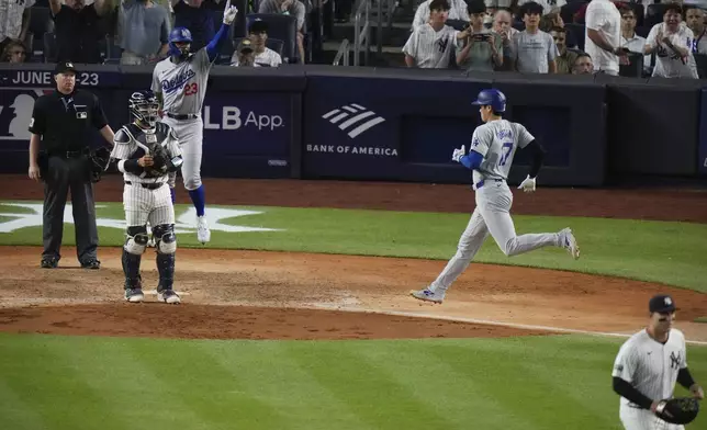 Los Angeles Dodgers' Shohei Ohtani heads home to score against the New York Yankees on a two-run double by Teoscar Hernández during the 11th inning of a baseball game, Friday, June 7, 2024, in New York. The Dodgers won 2-1. (AP Photo/Frank Franklin II)