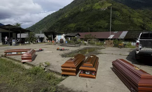 Coffins are prepared for the bodies of victims of a landslide caused by heavy rains in El Placer, Ecuador, Monday, June 17, 2024. (AP Photo/Dolores Ochoa)