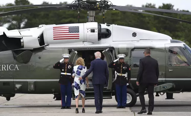 President Joe Biden, right, and first lady Jill Biden board Marine One at Francis S. Gabreski Airport, Saturday, June 29, 2024, in Westhampton Beach, N.Y. (AP Photo/Evan Vucci)