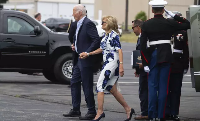 President Joe Biden, left, and first lady Jill Biden arrive at East Hampton Airport, Saturday, June 29, 2024, in East Hampton, N.Y. (AP Photo/Evan Vucci)