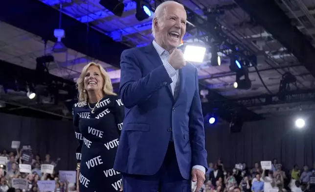 President Joe Biden, right, and first lady Jill Biden walk off stage after speaking at a campaign rally, Friday, June 28, 2024, in Raleigh, N.C. (AP Photo/Evan Vucci)