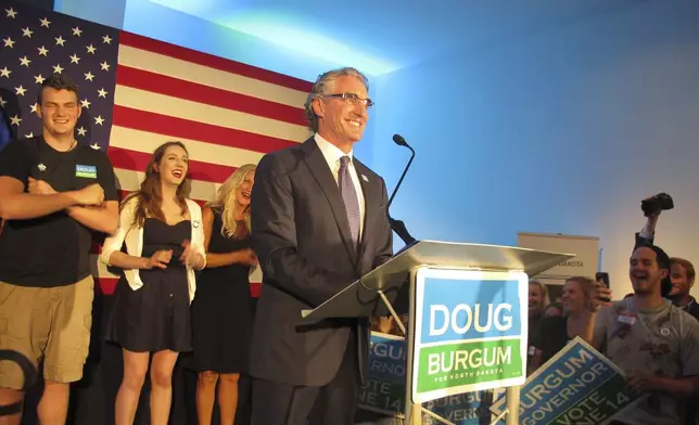 FILE - Republican gubernatorial candidate Doug Burgum talks to supporters at an art gallery in downtown Fargo, N.D., after Burgum won the GOP primary vote June 14, 2016. (AP Photo/Dave Kolpack, File)