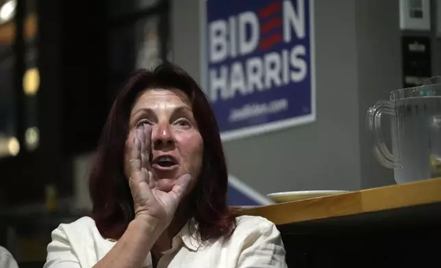 Lynn Miller shouts at the TV after a comment by Republican presidential candidate former President Donald Trump during the presidential debate with President Joe Biden, during a watch party at Broadway Bowl, Thursday, June 27, 2024, in South Portland, Maine. (AP Photo/Robert F. Bukaty)