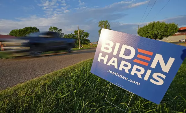 Traffic streaks past signage supporting President Joe Biden and Vice President Kamala Harris outside the Stronger Hope Church in Jackson, Miss., Thursday, June 27, 2024, prior to Biden's televised debate with former President Donald Trump. (AP Photo/Rogelio V. Solis)