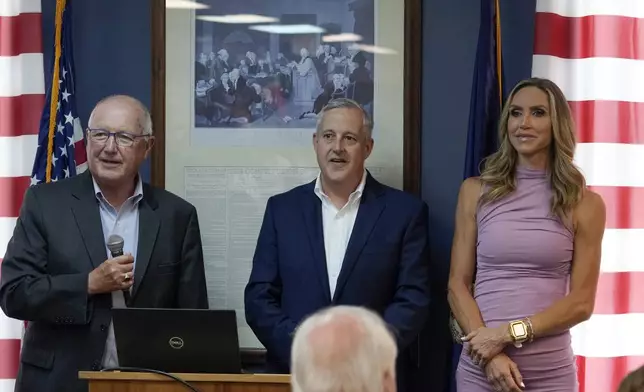 Michigan Republican Party Chairman Pete Hoekstra, left, Republican National Committee Co-chair Michael Whatley and Co-chair Lara Trump take questions at the Oakland County GOP Headquarters, Friday, June 14, 2024 in Bloomfield Hills, Mich. (AP Photo/Carlos Osorio)