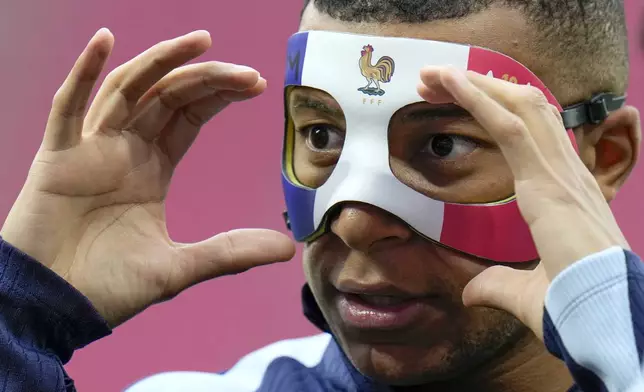 France's Kylian Mbappe adjusts his face mask during a training session in Leipzig, Germany, Thursday, June 20, 2024. France will play against Netherland during their Group D soccer match at the Euro 2024 soccer tournament on June 21. (AP Photo/Hassan Ammar)