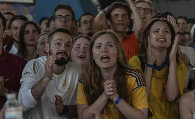 Ukraine fans react during a public screening of the Euro 2024 soccer match between Ukraine and Belgium in Kyiv, Ukraine, on Wednesday, June 26, 2024. (AP Photo/Alex Babenko)