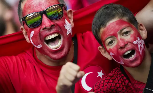 Turkish supporters cheer at the stand ahead of a Group F match between Czech Republic and Turkey at the Euro 2024 soccer tournament in Hamburg, Germany, Wednesday, June 26, 2024. (AP Photo/Ebrahim Noroozi)