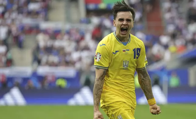 Ukraine's Mykola Shaparenko celebrates after scoring his side's opening goal during a Group E match between Slovakia and Ukraine at the Euro 2024 soccer tournament in Duesseldorf, Germany, Friday, June 21, 2024. (Rolf Vennenbernd/dpa via AP)