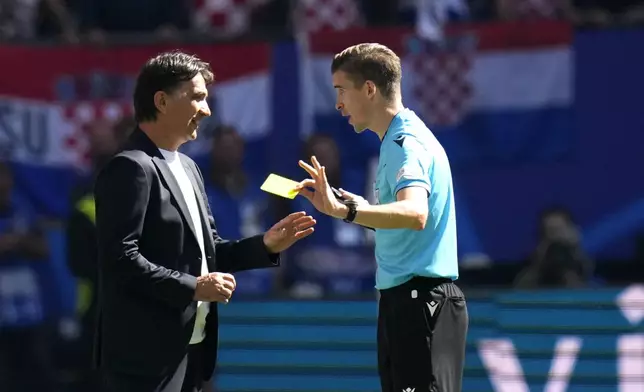 referee François Letexier of France, right, has a word with Croatia's head coach Zlatko Dalic during a Group B match between Croatia and Albania at the Euro 2024 soccer tournament in Hamburg, Germany, Wednesday, June 19, 2024. (AP Photo/Petr Josek)