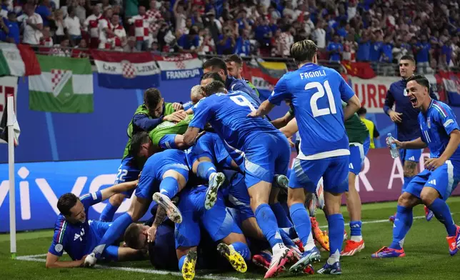 Italian players celebrate after teammate Mattia Zaccagni scored during a Group B match between Croatia and Italy at the Euro 2024 soccer tournament in Leipzig, Germany, Monday, June 24, 2024. (AP Photo/Petr David Josek)