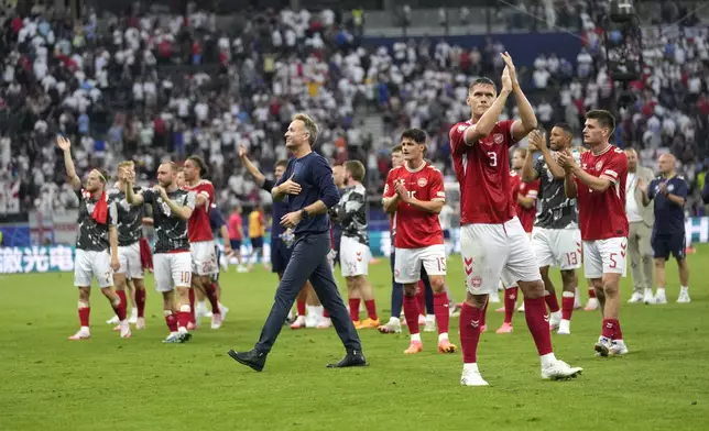Denmark's head coach Kasper Hjulmand and players at the end of a Group C match between Denmark and England at the Euro 2024 soccer tournament in Frankfurt, Germany, Thursday, June 20, 2024. (AP Photo/Sergei Grits)