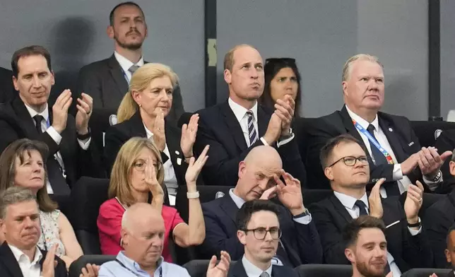 Britain's Prince William, top center, applauds during a Group C match between Denmark and England at the Euro 2024 soccer tournament in Frankfurt, Germany, Thursday, June 20, 2024. (AP Photo/Themba Hadebe)