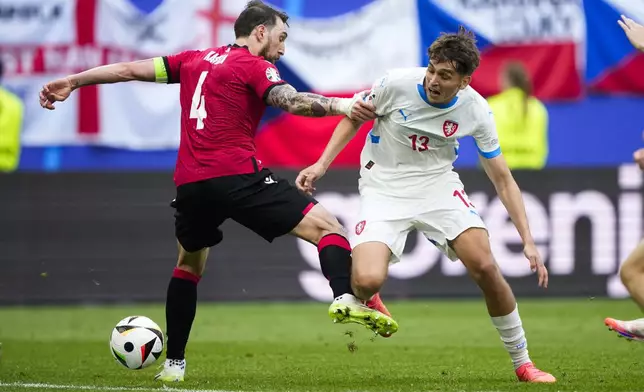 Georgia's Guram Kashia, left, and Czech Republic's Mojmir Chytil challenge for the ball during a Group F match between Georgia and the Czech Republic at the Euro 2024 soccer tournament in Hamburg, Germany, Saturday, June 22, 2024. (AP Photo/Ebrahim Noroozi)