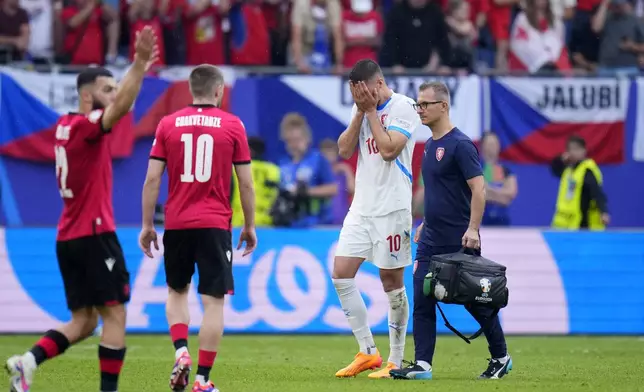 Czech Republic's Patrik Schick, center, leaves the pitch after getting injured during a Group F match between Georgia and the Czech Republic at the Euro 2024 soccer tournament in Hamburg, Germany, Saturday, June 22, 2024. (AP Photo/Petr David Josek)