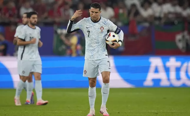 Portugal's Cristiano Ronaldo gestures after Georgia's Georges Mikautadze scored his side's second goal during a Group F match between Georgia and Portugal at the Euro 2024 soccer tournament in Gelsenkirchen, Germany, Wednesday, June 26, 2024. (AP Photo/Alessandra Tarantino)