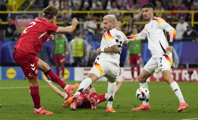Denmark's Joachim Andersen scores a goal which was disallowed during a round of sixteen match between Germany and Denmark at the Euro 2024 soccer tournament in Dortmund, Germany, Saturday, June 29, 2024. (AP Photo/Frank Augstein)