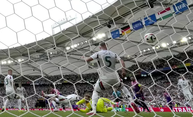 Germany's Jamal Musiala, third left, scores the opening goal during a Group A match between Germany and Hungary at the Euro 2024 soccer tournament in Stuttgart, Germany, Wednesday, June 19, 2024. (AP Photo/Antonio Calanni)