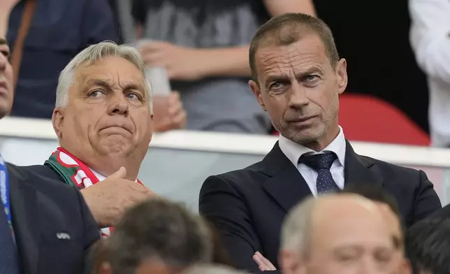 Hungary's Prime Minister Viktor Orban talks with UEFA President Aleksander Ceferin prior to the start of a Group A match between Germany and Hungary at the Euro 2024 soccer tournament in Stuttgart, Germany, Wednesday, June 19, 2024. (AP Photo/Antonio Calanni)