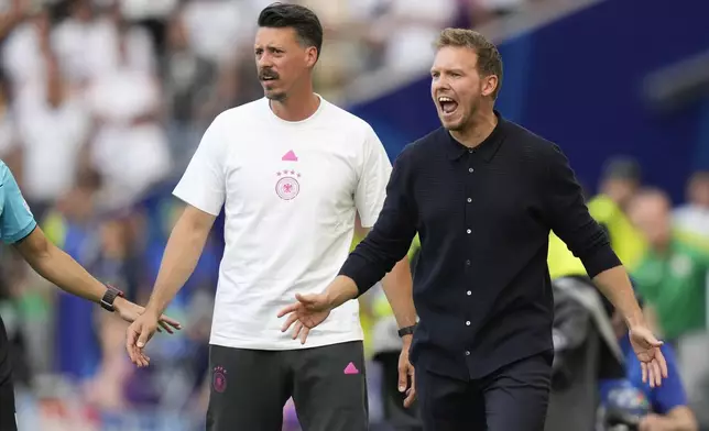 Germany's head coach Julian Nagelsmann, right, and assistant coach Sandro Wagner react during a Group A match between Germany and Hungary at the Euro 2024 soccer tournament in Stuttgart, Germany, Wednesday, June 19, 2024. (AP Photo/Matthias Schrader)