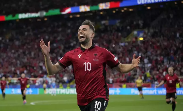 Albania's Nedim Bajrami celebrates after scoring his side's opening goal during a Group B match between Italy and Albania at the Euro 2024 soccer tournament in Dortmund, Germany, Saturday, June 15, 2024. (AP Photo/Alessandra Tarantino)