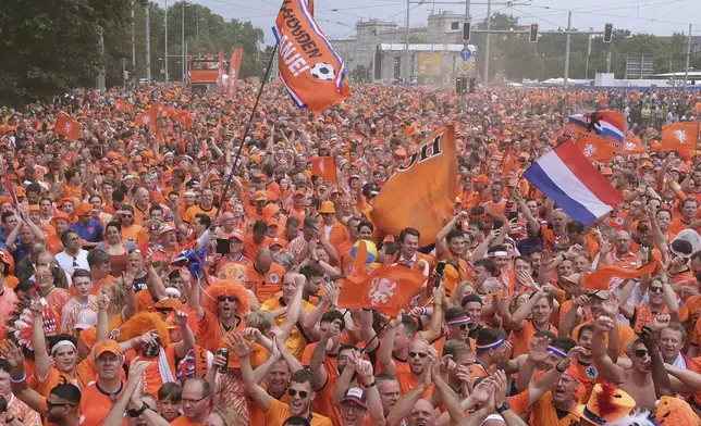 Netherlands fans gather in Leipzig, Germany, Friday June 21, 2024, ahead of the Group D match between the Netherlands and France at the Euro 2024 soccer tournament. (Sebastian Willnow/dpa via AP)