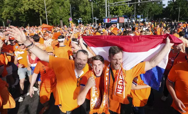 Dutch supporters arrive for the Group D match between the Netherlands and France at the Euro 2024 soccer tournament in Leipzig, Germany, Friday, June 21, 2024. (AP Photo/Hassan Ammar)