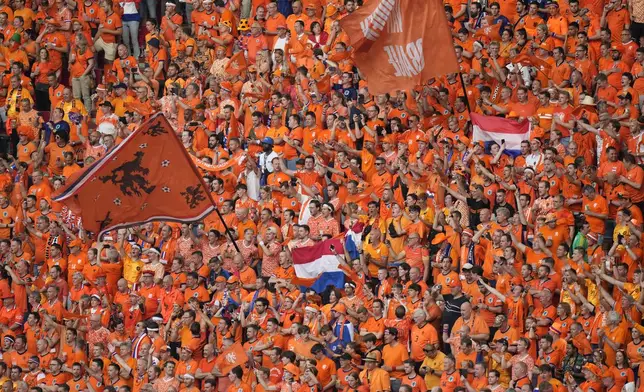 Dutch fans cheer for their national team ahead of a Group D match between the Netherlands and France at the Euro 2024 soccer tournament in Leipzig, Germany, Friday, June 21, 2024. (AP Photo/Sergei Grits)