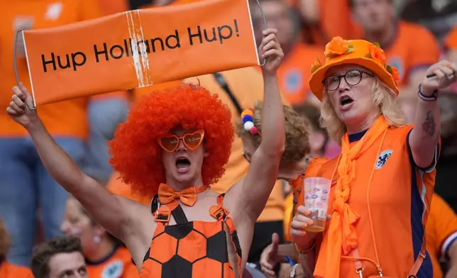 Fans of the Dutch soccer team cheer prior to a Group D match between the Netherlands and France at the Euro 2024 soccer tournament in Leipzig, Germany, Friday, June 21, 2024. (AP Photo/Mathias Schrader)