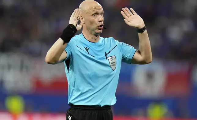 Referee Anthony Taylor gestures during the Group D match between the Netherlands and France at the Euro 2024 soccer tournament in Leipzig, Germany, Friday, June 21, 2024. (AP Photo/Hassan Ammar)