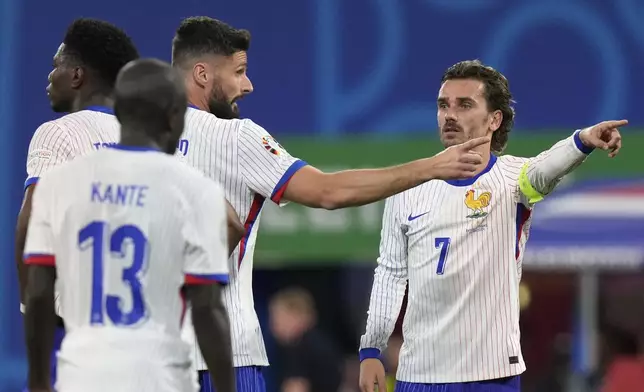 Antoine Griezmann of France, right, gestures to teammates during a Group D match between the Netherlands and France at the Euro 2024 soccer tournament in Leipzig, Germany, Friday, June 21, 2024. (AP Photo/Mathias Schrader)