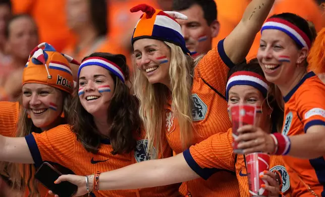 Fans of the Dutch soccer team cheer prior to a Group D match between the Netherlands and France at the Euro 2024 soccer tournament in Leipzig, Germany, Friday, June 21, 2024. (AP Photo/Mathias Schrader)