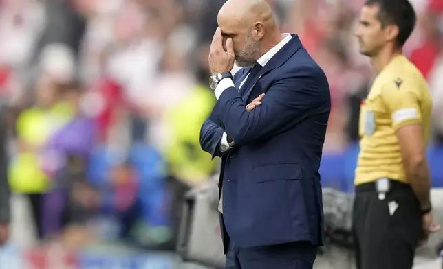 Poland' head coach Michal Probierz covers his face during a Group D match between Poland and Austria at the Euro 2024 soccer tournament in Berlin, Germany, Friday, June 21, 2024. (AP Photo/Ebrahim Noroozi)