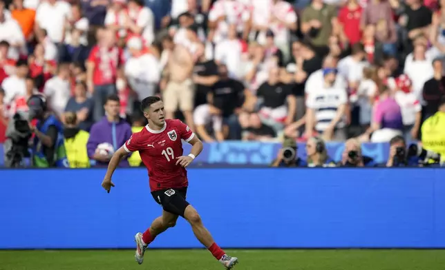 Austria's Christoph Baumgartner celebrates after scoring his side's second goal during a Group D match between Poland and Austria at the Euro 2024 soccer tournament in Berlin, Germany, Friday, June 21, 2024. (AP Photo/Ebrahim Noroozi)