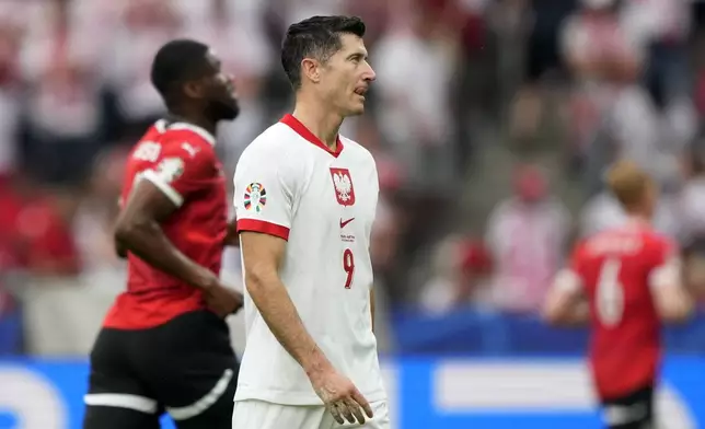 Poland's Robert Lewandowski reacts after the third goal of Austria during a Group D match between Poland and Austria at the Euro 2024 soccer tournament in Berlin, Germany, Friday, June 21, 2024. (AP Photo/Ebrahim Noroozi)