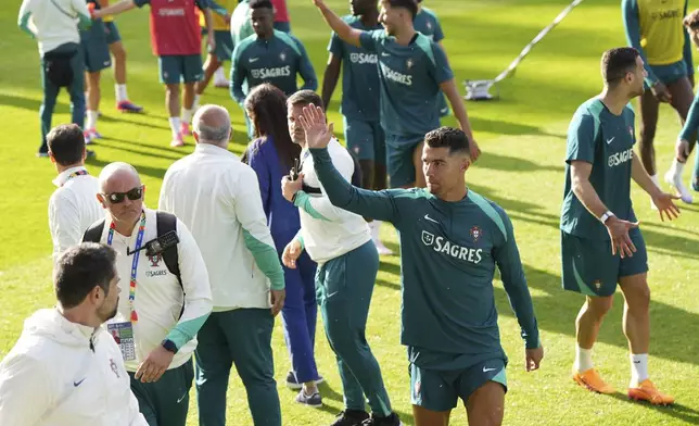 Portugal's Cristiano Ronaldo applauds fans at the end of a training session in Gutersloh, Germany, Friday, June 14, 2024. Portugal will play against Czech Republic during their Group F soccer match at the Euro 2024 soccer tournament on June 18. (AP Photo/Hassan Ammar)
