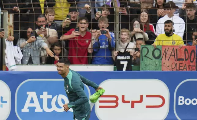 Portugal's Cristiano Ronaldo warms up during a training session in Gutersloh, Germany, Friday, June 14, 2024. Portugal will play against Czech Republic during their Group F soccer match at the Euro 2024 soccer tournament on June 18. (AP Photo/Hassan Ammar)