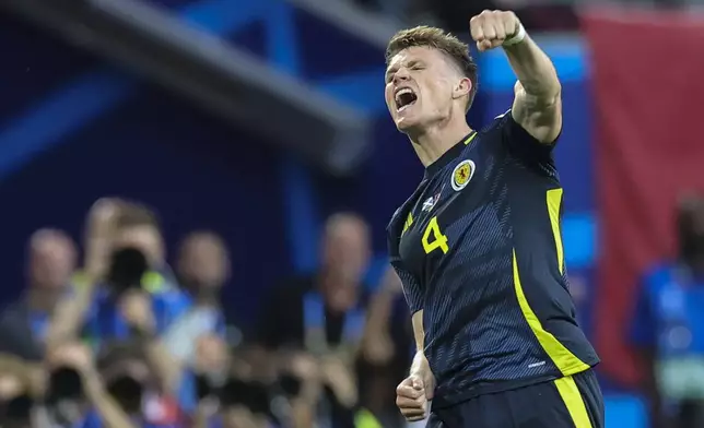 Scotland's Scott McTominay celebrates after Switzerland's Fabian Schar scored an own goal during a Group A match between Scotland and Switzerland at the Euro 2024 soccer tournament in Cologne, Germany, Wednesday, June 19, 2024. (Rolf Vennenbernd/dpa via AP)