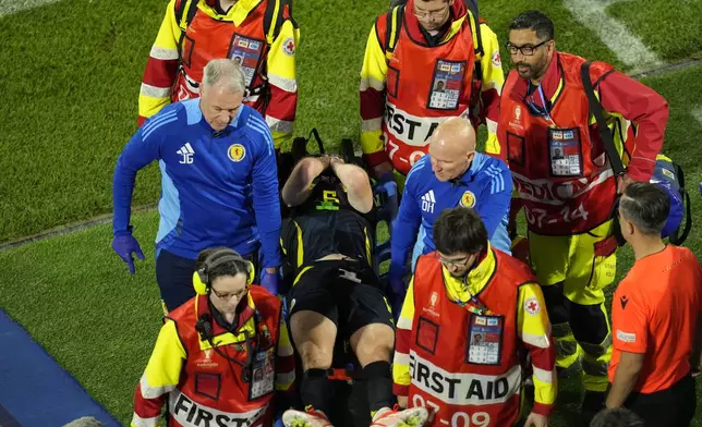 Scotland's Kieran Tierney is stretchered off the pitch during a Group A match between Scotland and Switzerland at the Euro 2024 soccer tournament in Cologne, Germany, Wednesday, June 19, 2024. (AP Photo/Andreea Alexandru)