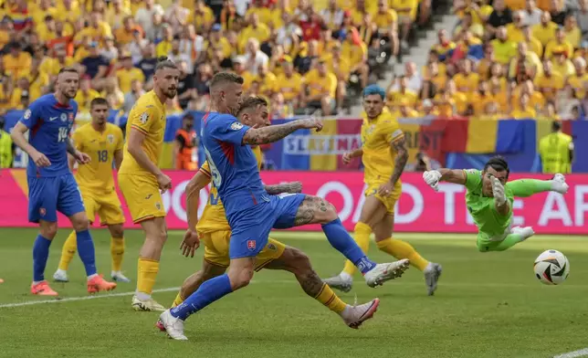 Slovakia's Juraj Kucka, front, tries a shot during a Group E match between Slovakia and Romania at the Euro 2024 soccer tournament in Frankfurt, Germany, Wednesday, June 26, 2024. (AP Photo/Frank Augstein)